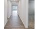 Inviting hallway with modern wood floors leads to a bright living space with sliding glass doors at 2656 Tillman St, Monroe, NC 28112