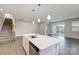Bright kitchen island with view of staircase, living room, and sliding glass doors at 2656 Tillman St, Monroe, NC 28112