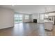 Bright living room with sliding glass doors, fireplace, and a modern kitchen with island at 2656 Tillman St, Monroe, NC 28112