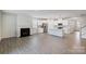 Open-concept living room with fireplace and modern kitchen featuring stainless steel appliances at 2656 Tillman St, Monroe, NC 28112