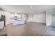 Spacious living area with modern kitchen and a view of the staircase to the upper level at 2656 Tillman St, Monroe, NC 28112