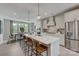 Well-lit kitchen with an island, stainless steel appliances, and a dining area view at 3210 Stelfox St, Charlotte, NC 28262