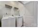 Bright laundry room includes shelving with a washer and dryer, for ease of use at 3210 Stelfox St, Charlotte, NC 28262