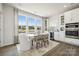 Cozy dining area with large windows, modern table set, and elegant built-in cabinets at 3218 Stelfox St, Charlotte, NC 28262