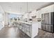 A bright, modern kitchen has stainless steel appliances, pendant lights, and an island with barstool seating at 3218 Stelfox St, Charlotte, NC 28262