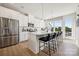 Modern kitchen featuring white cabinets, a spacious island with bar seating, and stainless steel appliances at 3222 Stelfox St, Charlotte, NC 28262