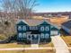 Aerial view of the two-story home with blue siding and mature trees at 388 Luray Way, Rock Hill, SC 29730
