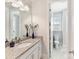 Bright bathroom featuring granite counters, white cabinetry and marble floors at 388 Luray Way, Rock Hill, SC 29730