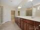 Primary bathroom with dual sinks, granite counters, custom cabinets and large walk-in closet at 4030 Ambleside Dr, Fort Mill, SC 29707