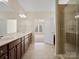 Bathroom with dual sinks, granite counters, custom cabinets and adjacent to glass shower at 4030 Ambleside Dr, Fort Mill, SC 29707