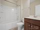 Bathroom features a shower-tub combo, vanity with custom cabinets, and neutral tile flooring at 4030 Ambleside Dr, Fort Mill, SC 29707