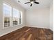 Cozy bedroom with hardwood floors, a ceiling fan, and bright windows overlooking the yard at 4030 Ambleside Dr, Fort Mill, SC 29707