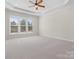 Spacious bedroom with neutral carpet, trim and walls; has multiple windows at 4030 Ambleside Dr, Fort Mill, SC 29707