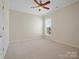 Bright bedroom with a ceiling fan, plush carpeting, and a large window at 4030 Ambleside Dr, Fort Mill, SC 29707