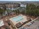 Inviting community pool with unique design, surrounded by seating, cabanas, and parking at 4030 Ambleside Dr, Fort Mill, SC 29707