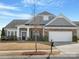 Charming single Gathering home featuring stone accents, manicured lawn and two car garage at 4030 Ambleside Dr, Fort Mill, SC 29707