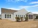 Rear exterior showing siding, many windows, patio, screened-in porch, and fire pit at 4030 Ambleside Dr, Fort Mill, SC 29707