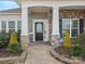 Inviting front porch with stone columns and manicured landscaping, leading to a beautiful front door at 4030 Ambleside Dr, Fort Mill, SC 29707