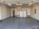 Spacious three car garage with epoxy flooring, utility sink, and white refrigerator at 4030 Ambleside Dr, Fort Mill, SC 29707