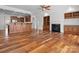 Open living room with fireplace and built-in bookshelves adjoining kitchen at 4030 Ambleside Dr, Fort Mill, SC 29707