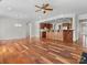 Open concept living room and kitchen area with wood floors and ample lighting at 4030 Ambleside Dr, Fort Mill, SC 29707