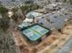 Aerial view of active pickleball courts in a vibrant community setting with shaded seating at 4030 Ambleside Dr, Fort Mill, SC 29707