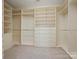 Organized walk-in closet system with custom shelving, drawers, and ample storage space at 4030 Ambleside Dr, Fort Mill, SC 29707