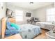 Bedroom with light walls, hardwood floors, and two beds with blue pillows at 4455 Hampton Rd, Salisbury, NC 28144