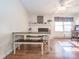 Bright dining room featuring a white brick fireplace, bench seating, and a ceiling fan at 4455 Hampton Rd, Salisbury, NC 28144