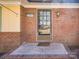 Close-up of the front door with brick surround, house number and covered porch at 4455 Hampton Rd, Salisbury, NC 28144