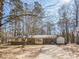 Single-story home with a carport and storage shed nestled among mature trees at 4455 Hampton Rd, Salisbury, NC 28144