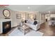 Comfortable living room with a fireplace, neutral-toned sofa, wood floors, and access to kitchen at 463 Zender Ln, Monroe, NC 28112