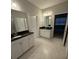 Bright bathroom features double vanity with black countertop and white cabinets and tile floors at 509 Belle Grove Dr, Clover, SC 29710