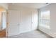 Bedroom with neutral carpet, bright window, and direct access to hallway at 5120 Fireweed Ct, Dallas, NC 28034