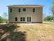 Beige two-story home exterior featuring multiple windows and a white double door at 5311 Meadowland Pkwy, Monroe, NC 28112