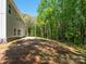 Large backyard with a backdrop of tall green trees, offering a private and serene outdoor space for relaxation at 5311 Meadowland Pkwy, Monroe, NC 28112