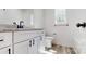 Bathroom featuring modern black fixtures, white cabinetry, and a sleek countertop at 5311 Meadowland Pkwy, Monroe, NC 28112