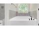 Bright bathroom features a large soaking tub and dark bronze hardware at 5311 Meadowland Pkwy, Monroe, NC 28112