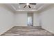 This bedroom has a tray ceiling, ceiling fan, and light vinyl floors at 5311 Meadowland Pkwy, Monroe, NC 28112
