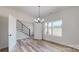 Dining area featuring modern lighting, hardwood floors, and access to the staircase at 5311 Meadowland Pkwy, Monroe, NC 28112