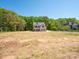 Elegant new construction home with a lush green backdrop and blue sky at 5311 Meadowland Pkwy, Monroe, NC 28112
