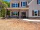 Inviting front porch with stone pillars and a dark wood door, perfect for welcoming guests to the beautiful home at 5311 Meadowland Pkwy, Monroe, NC 28112