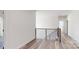 Hallway with a wooden staircase and matching vinyl flooring at 5311 Meadowland Pkwy, Monroe, NC 28112
