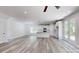 Bright open-concept living area with sleek wood flooring, white walls, and modern kitchen at 5311 Meadowland Pkwy, Monroe, NC 28112
