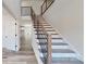 Modern staircase with wood steps and sleek black metal railings leading to the second floor at 5311 Meadowland Pkwy, Monroe, NC 28112