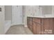 Bathroom with granite counters, cherry cabinets, and tile floors at 5417 Sustar Dr, Monroe, NC 28110