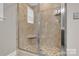 Glass enclosed shower with bench and mosaic tile floors at 5417 Sustar Dr, Monroe, NC 28110