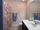 Bathroom showcasing a vanity with sink, tile floor, and a floral-patterned shower curtain at 5518 Prosperity View Dr, Charlotte, NC 28269