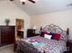 Bedroom featuring neutral walls, a floral comforter, a ceiling fan and ensuite bathroom at 5518 Prosperity View Dr, Charlotte, NC 28269