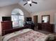 Bedroom featuring vaulted ceilings, a ceiling fan, natural lighting and dual dressers at 5518 Prosperity View Dr, Charlotte, NC 28269